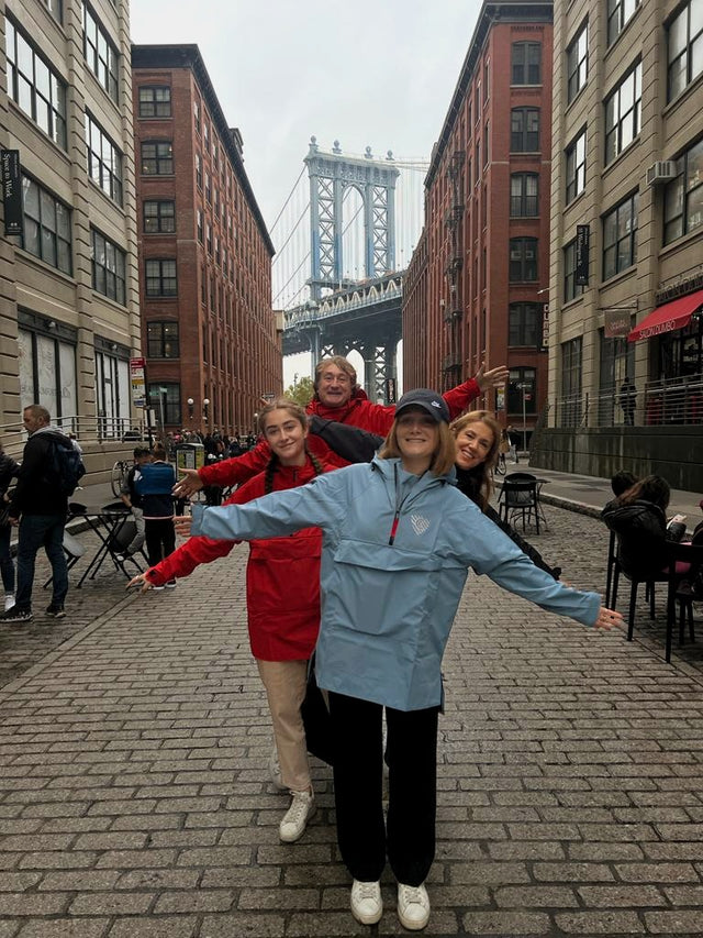 Family all wearing Cleverhood Anorak in DUMBO with Brooklyn Bridge in background
