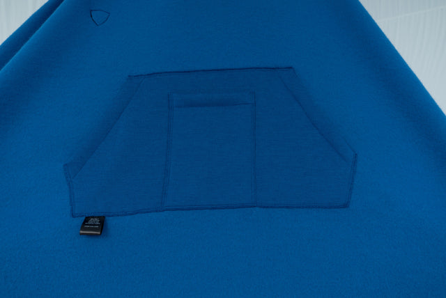 Constructed at Detroit's ISAIC (Industrial Sewing and Innovation Center). Cotton blend sweatshirt cape offers a freedom of movement – for men or women. Perfect for outdoor dining, beach walks and cozy campfires. A handy inside pocket with a second smaller pocket for your mobile device of choice. Hood has a sturdy, Herringbone twill patterned drawstring. Cozy soft cotton blended fleece/sweatshirt fabric. Machine washable.