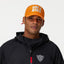 Person wearing an orange cap with 'Ride a Bike' text and a black jacket on a gray background