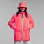 Person wearing a bright pink reflective rain jacket and hat on a plain background