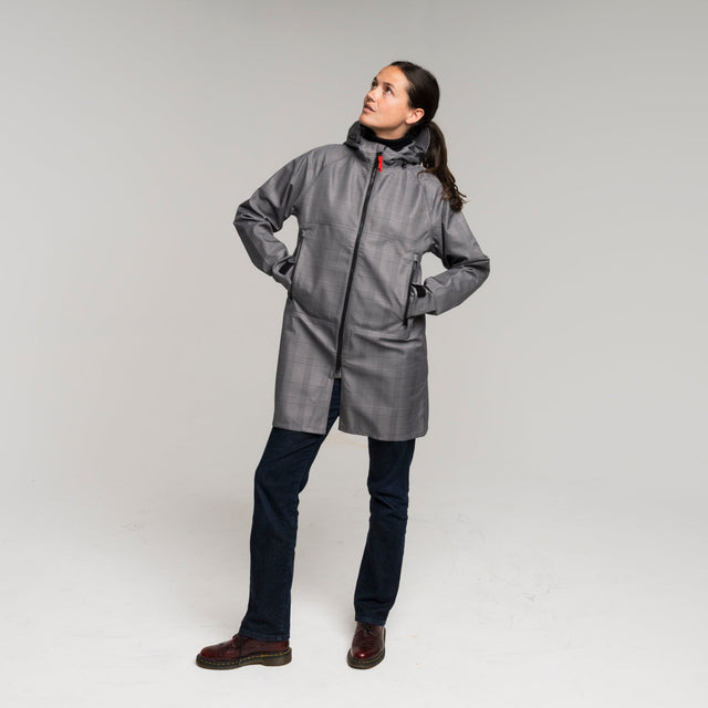 woman wearing a gray waterproof trench coat 